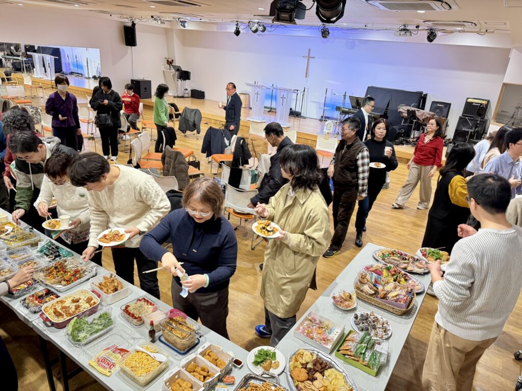 Church members sharing a Christmas fellowship meal at Shalom International.